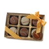 Box of chocolates with a gold ribbon on a white background