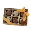 Box of chocolates with a gold ribbon on a white background