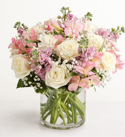 Bouquet of pink, white, and purple flowers in a clear glass vase on a white background Bouquet of pink, white, and purple flowers in a clear glass vase on a white background