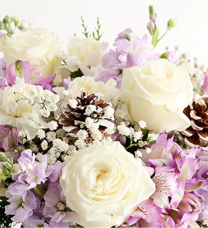 Bouquet of white and purple flowers with pinecones on a white background