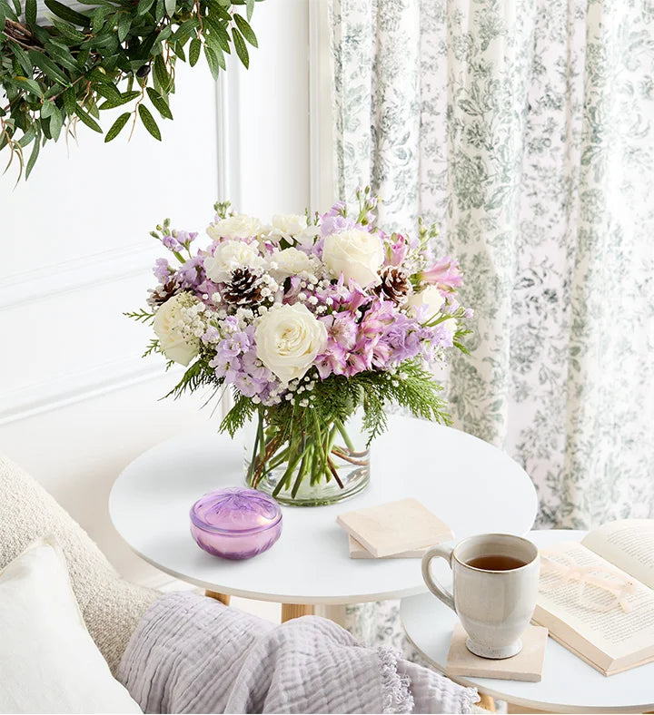 Lovely Lavender Medley for Winter Bouquet of flowers on a table with a cup of coffee and books in a cozy room.