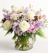 Lovely Lavender Medley for Winter Bouquet of white and purple flowers in a clear vase on a white background