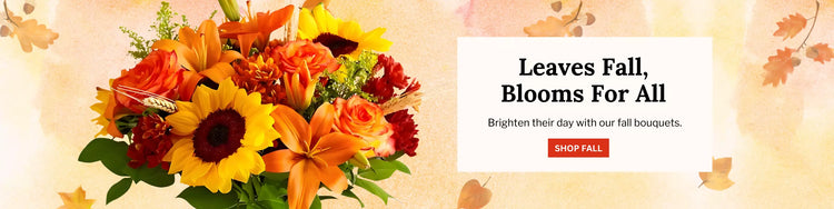 Festive fall bouquet with orange lilies, golden sunflowers, and red mums beside the text ‘Leaves Fall, Blooms For All – Brighten their day with our fall bouquets.