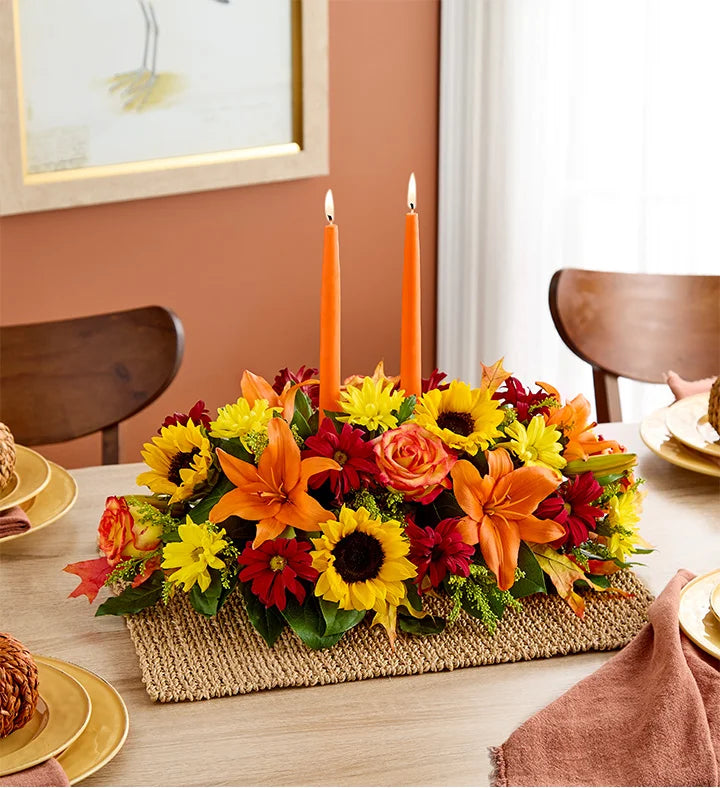 Fields of Europe for Fall Centerpiece, Colorful floral arrangement with candles on a dining table.