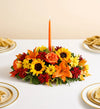 Fields of Europe for Fall Centerpiece, Colorful floral arrangement with a candle on a table setting.