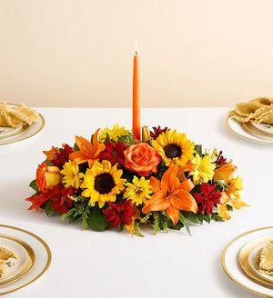 Fields of Europe for Fall Centerpiece, Colorful floral arrangement with a candle on a table setting.