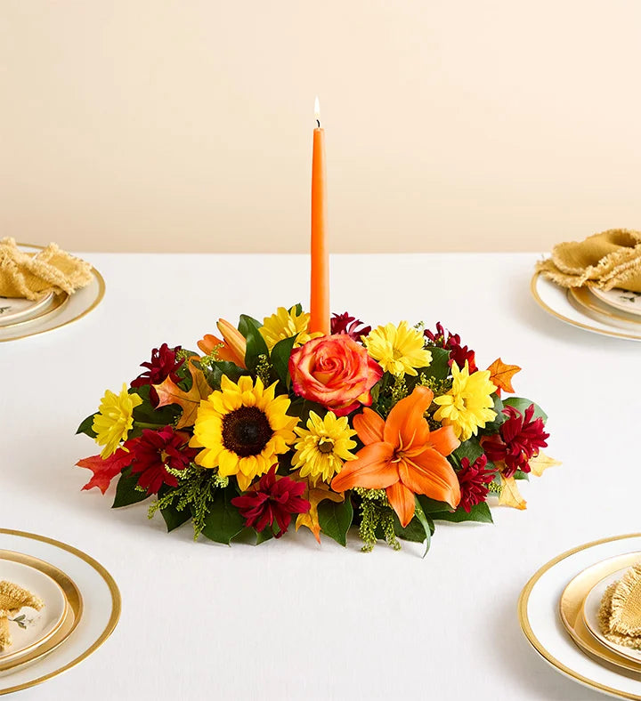 Fields of Europe for Fall Centerpiece, Colorful floral arrangement with a candle on a table setting.