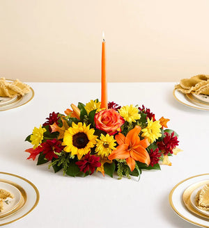 Fields of Europe for Fall Centerpiece, Colorful floral arrangement with a candle on a table setting.