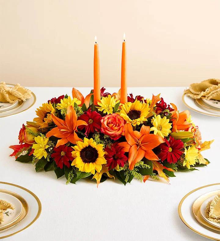 Fields of Europe for Fall Centerpiece, Colorful floral arrangement with candles on a table setting.