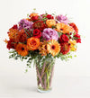 Garden of Grandeur for Fall Colorful bouquet of flowers in a clear vase on a white background