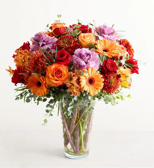 Garden of Grandeur for Fall Colorful bouquet of flowers in a clear vase on a white background