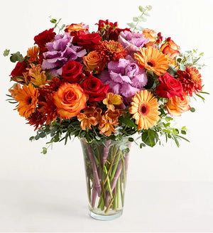 Garden of Grandeur for Fall Bouquet of colorful flowers in a clear vase on a white background