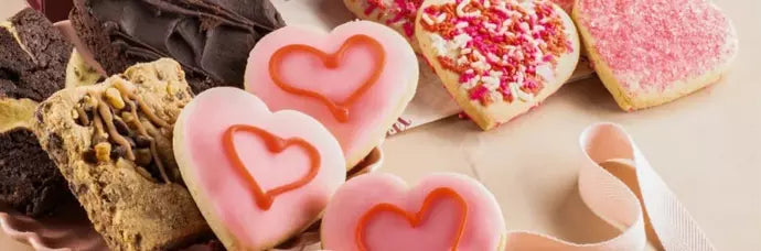 Assorted Valentine’s Day cookies and desserts decorated with heart designs and pink icing.