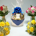 Gift basket with a blue bow surrounded by flowers on a light gray background