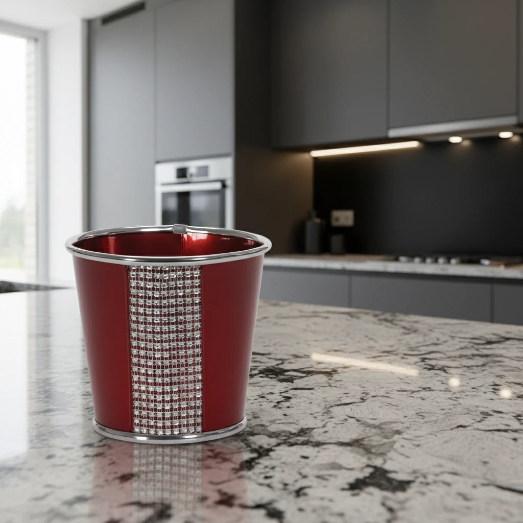 Red metal cup with silver rim and decorative pattern on a white background