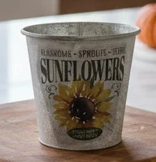 Medium keepsake tin container with sunflower design and text in a kitchen.