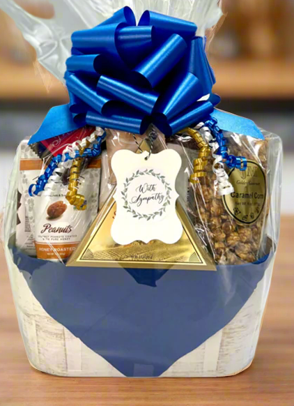 Gift basket with a blue bow in basket container on a light gray background.