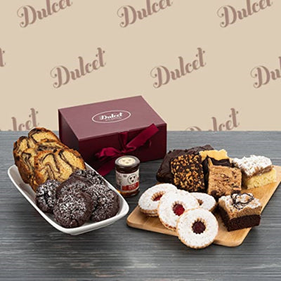 Assorted desserts on a wooden board with a 'Dulce' box in the background Assorted desserts on a wooden board with a 'Dulce' box in the background
