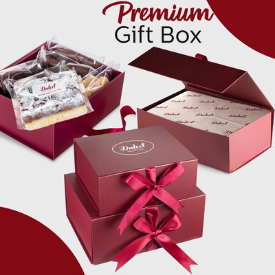 Red gift box with a ribbon, containing a small package, on a white background.
