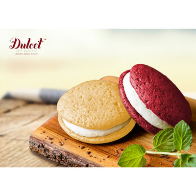 Two whoopie pies on a wooden board with 'Dulced' branding. Two whoopie pies on a wooden board with 'Dulced' branding.