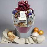 Gift basket with a variety of items including cookies and a card, on a gray background.