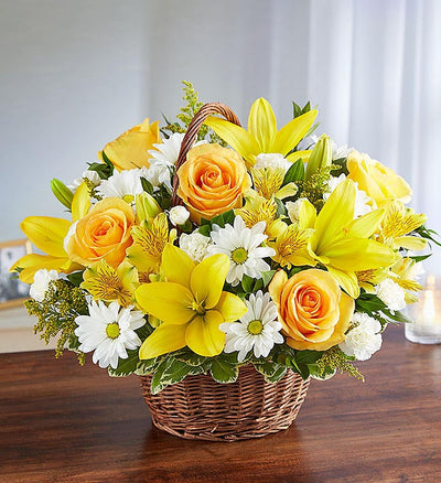 Large yellow and white floral arrangement in wicker basket featuring yellow roses, Asiatic lilies, alstroemeria, white daisy poms, and mini carnations with lush greenery, perfect for conveying support and blessings. Large yellow and white floral arrangement in wicker basket featuring yellow roses, Asiatic lilies, alstroemeria, white daisy poms, and mini carnations with lush greenery, perfect for conveying support and blessings.
