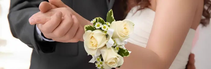 Sophisticated white rose boutonniere and corsage set from James Cress Florist, beautifully styled for prom night, weddings, and formal celebrations.